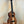 Wooden KoAloha KCM-10RP Concert Ukulele in Royal Pikake finish on a black stand