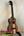 Wooden KoAloha KCM-10RP Concert Ukulele in Royal Pikake finish on a black stand
