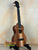 Wooden KoAloha KCM-10RP Concert Ukulele in Royal Pikake finish on a black stand