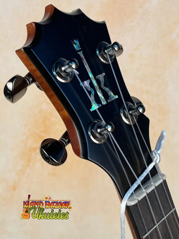 Guitar headstock with black finish and chrome tuning pegs on KoAloha KCM-10RP-MG Concert