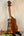 Wooden KoAloha KSM-00 ukulele on a black stand showcasing solid Hawaiian Koa craftsmanship