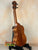 Wooden KoAloha KSM-00 ukulele on a black stand showcasing solid Hawaiian Koa craftsmanship
