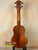 Wooden KoAloha KSM-00 featured soprano ukulele in natural finish on a black stand