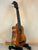 Wooden KoAloha KSM-00 Featured Soprano Ukulele with solid Hawaiian Koa on black stand