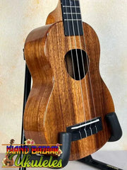 Wooden KoAloha KSM-00 Soprano Ukulele with Hawaiian Koa and ebony fretboard on black stand