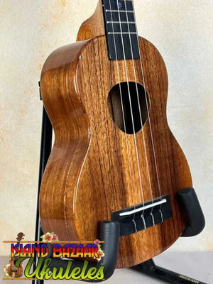 Wooden KoAloha KSM-00 Soprano Ukulele with Hawaiian Koa and ebony fretboard on black stand