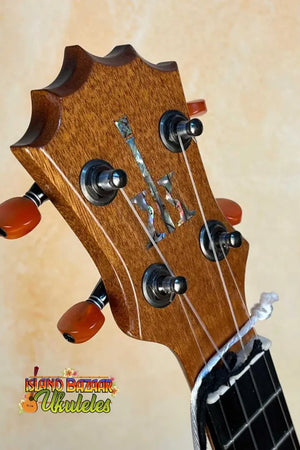 Guitar headstock with decorative inlay and tuning pegs on KoAloha KSM-00 Soprano Ukulele