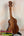 Wooden KoAloha KSM-10 Soprano Ukulele with striped grain on black stand, Pikake Satin Finish