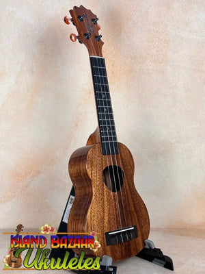 Wooden KoAloha KSM-10 Soprano Ukulele with dark grain and Pikake Satin Finish on stand