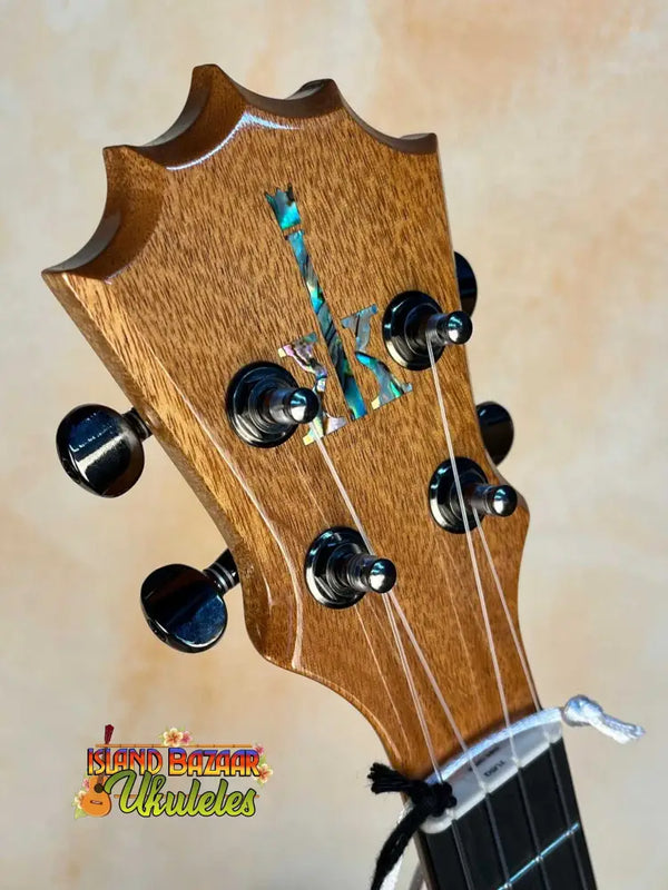 Guitar headstock of KoAloha KTM-00 MG Mango Tenor Ukulele with black tuning pegs