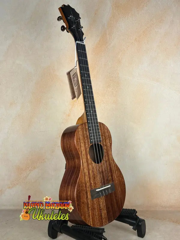 Wooden Koaloha KTM-00 Tenor Ukulele with solid Hawaiian koa and exceptional tone on stand