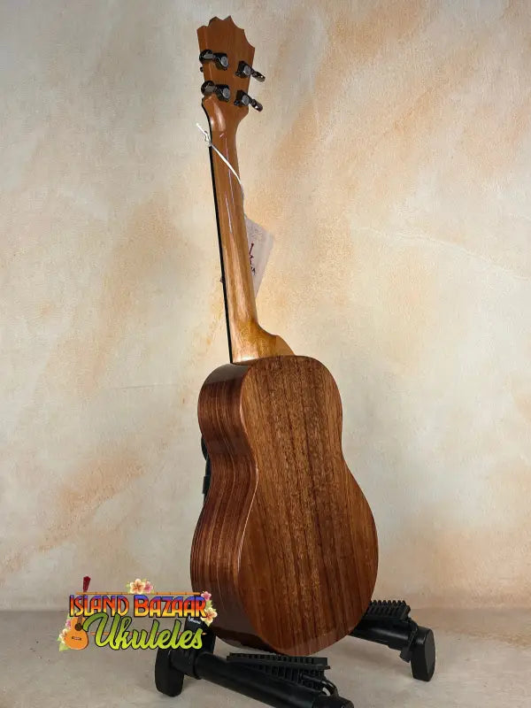 Wooden acoustic guitar on a stand showcasing Koaloha KTM-00 Tenor with exceptional tone