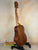 Wooden acoustic guitar on a stand showcasing Koaloha KTM-00 Tenor with exceptional tone