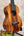 A koaloha ktm-00 tenor ukulele with glossy mahogany wood grain and black fretboard delivering authentic hawaiian sound