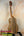 Wooden KoAloha KTM-10RP-MG Tenor Mango Ukulele with dark grain on a stand