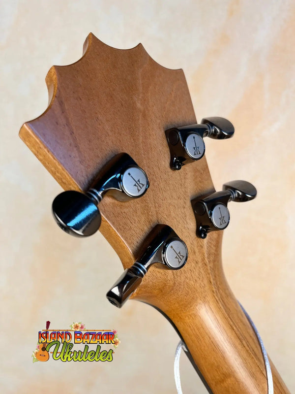 Wooden guitar headstock with black tuning pegs on KoAloha KTM-10RP-MG Tenor Mango Ukulele