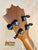 Wooden guitar headstock with black tuning pegs on KoAloha KTM-10RP-MG Tenor Mango Ukulele