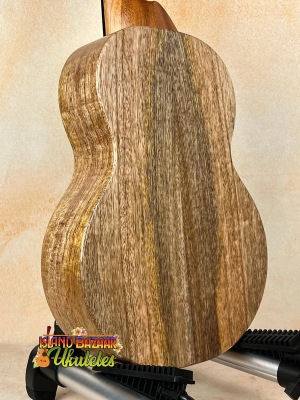 Wooden acoustic guitar showcasing wood grain in KoAloha KTM-10RP-MG Tenor Mango Ukulele