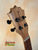 Wooden headstock of KoAloha KTO-10 Opio Tenor Ukulele with black tuning pegs