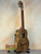 Wooden KoAloha KTO-10 Opio Tenor Ukulele on black stand with gig bag