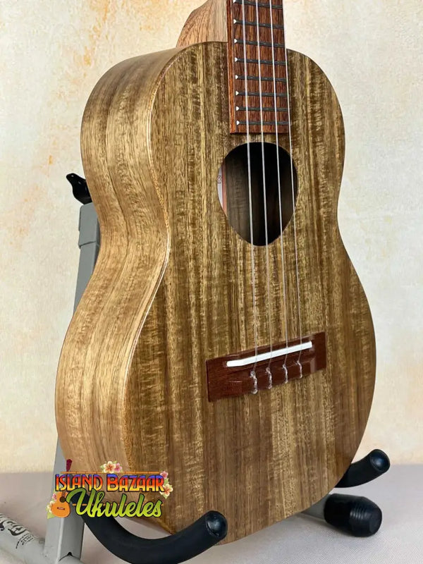 Wooden KoAloha KTO-10 Opio Tenor Ukulele with natural grain finish on black stand