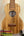 Wooden ukulele with natural finish, showcasing wood grain pattern in KoAloha Opio Concert