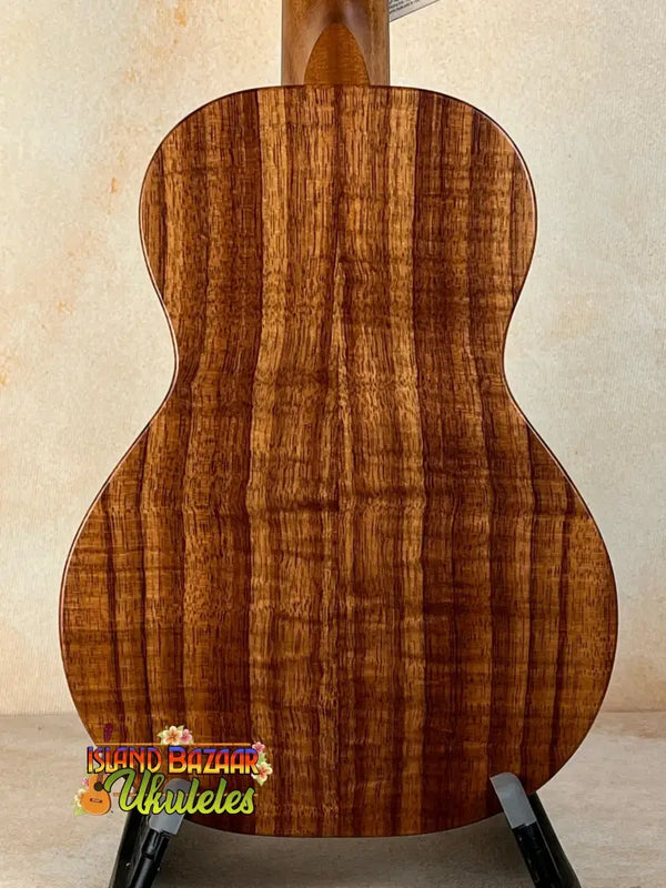 Acoustic guitar featuring richly striped Koa wood back panel of KoAloha Royal Pikake Concert