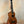 Wooden ukulele with dark grain patterns and black pegs, featuring KoAloha Royal Pikake KCM-00RP