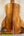 Acoustic guitar with koa wood back panel on stand, showcasing KoAloha Royal Pikake Concert