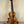 Wooden KoAloha Royal Pikake Concert Ukulele with dark fretboard on display stand