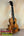 Wooden KoAloha Royal Pikake Concert Ukulele with dark fretboard on display stand