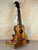 Wooden KoAloha Royal Pikake Concert Ukulele with dark fretboard on display stand