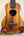 Wooden ukulele with koa finish and black fretboard, perfect for the KoAloha Royal Pikake Concert