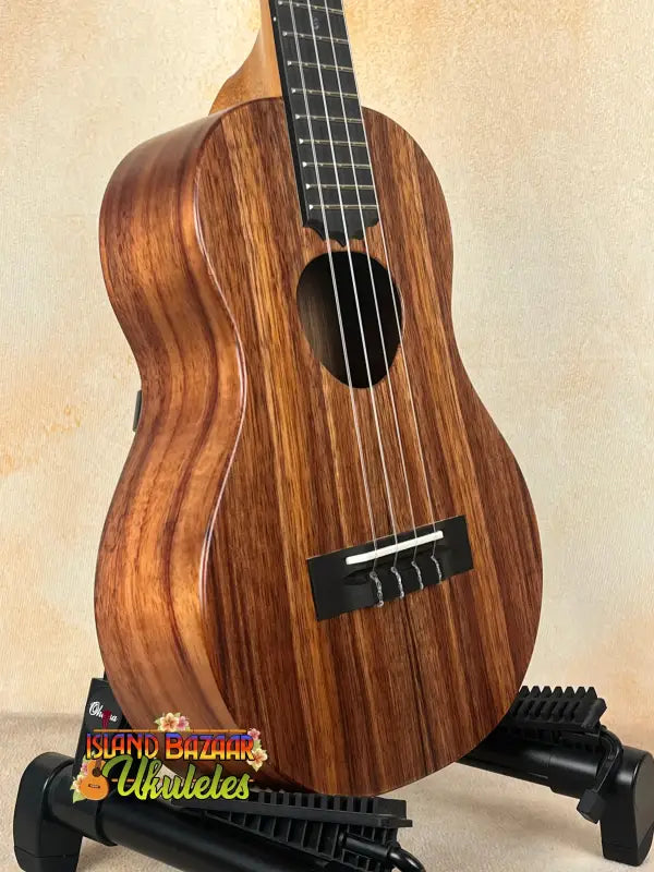 Wooden ukulele on stand, Koaloha Royal Pikake Tenor Uke with solid Hawaiian koa