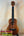 Wooden ukulele with dark fretboard and natural grain, Koaloha Royal Pikake Tenor