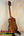 Wooden Koaloha Royal Pikake Tenor Ukulele on a black stand with satin-finish koa