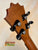 Guitar headstock with black tuning pegs on solid Hawaiian Koa of Koaloha Royal Pikake