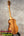 Light-colored wooden Koaloha Tenor ukulele with matte finish on dark stand showcasing Hawaiian ukulele craftsmanship