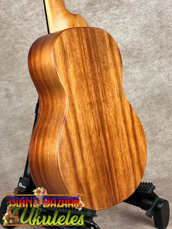 Wooden Koaloha Tenor Ukulele with prominent grain pattern and matte finish showcasing Hawaiian craftsmanship