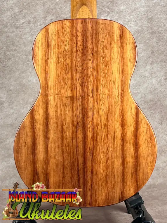 Koaloha Tenor acoustic guitar with rich reddish-brown wood grain and matte finish