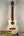 Light-colored wooden KoAloha Tenor Opio ukulele with heart-shaped sound hole
