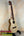 Natural wood KoAloha Tenor Opio Solid Spruce/Solid Acacia Ukulele on black stand