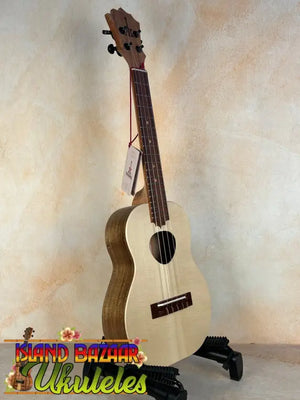 Natural wood KoAloha Tenor Opio Solid Spruce/Solid Acacia Ukulele on black stand