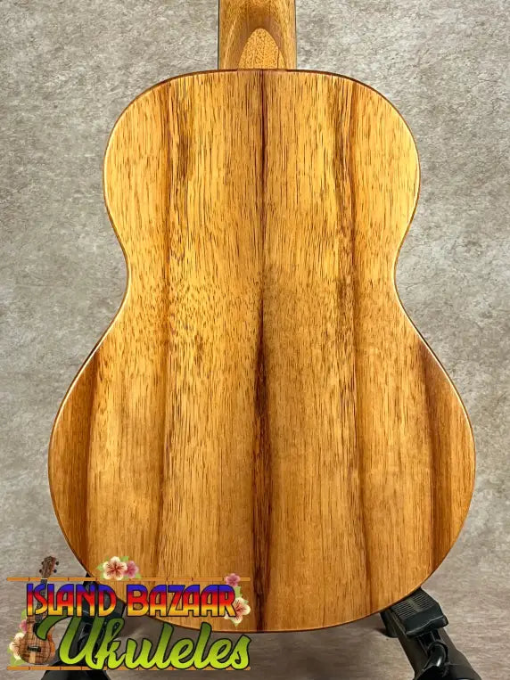 Light brown wooden Koaloha Royal Pikake tenor ukulele with vertical grain and solid Hawaiian koa