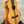 Light-colored wooden Koaloha Royal Pikake Tenor Ukulele with solid Hawaiian koa finish on stand