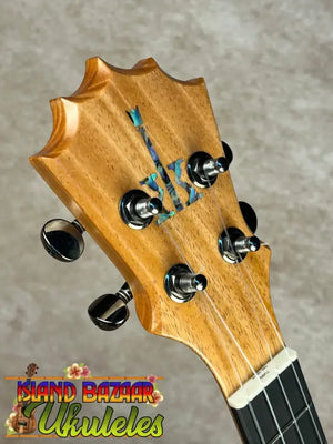 Headstock of Koaloha Royal Pikake tenor ukulele with mother-of-pearl inlay and chrome tuners