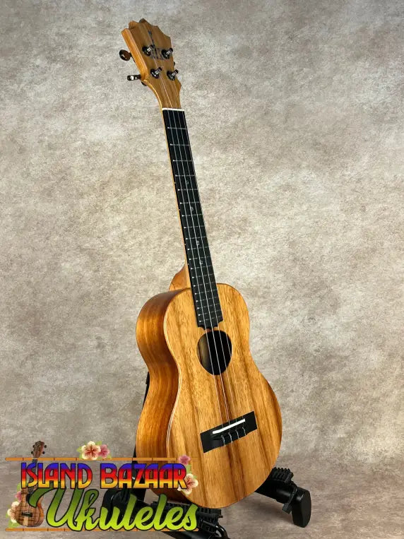 Wooden ukulele with black fretboard and tuning pegs from Koaloha Royal Pikake tenor line