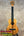 Light brown wooden Koaloha Royal Pikake tenor ukulele with black fretboard and bridge