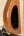 Wooden guitar body of Mann Electric Tenor Ukulele with oval sound hole and screws