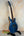Blue electric guitar with flamed maple top on stand from Mann Electric Tenor Ukulele